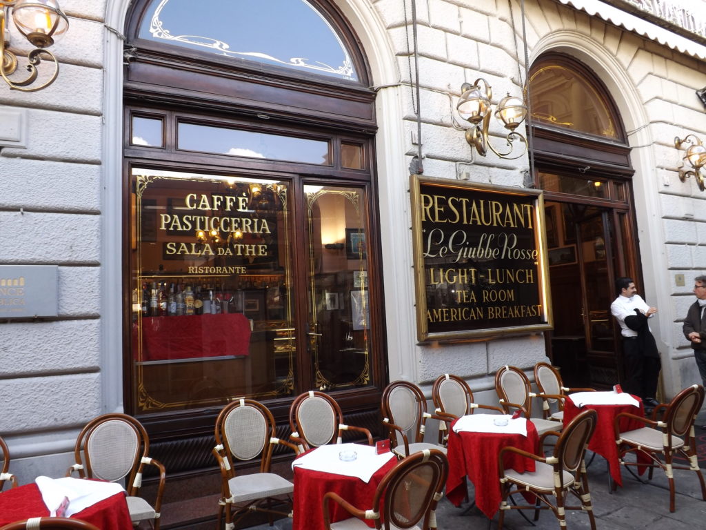 windows and tables in front of Guibbe Rose