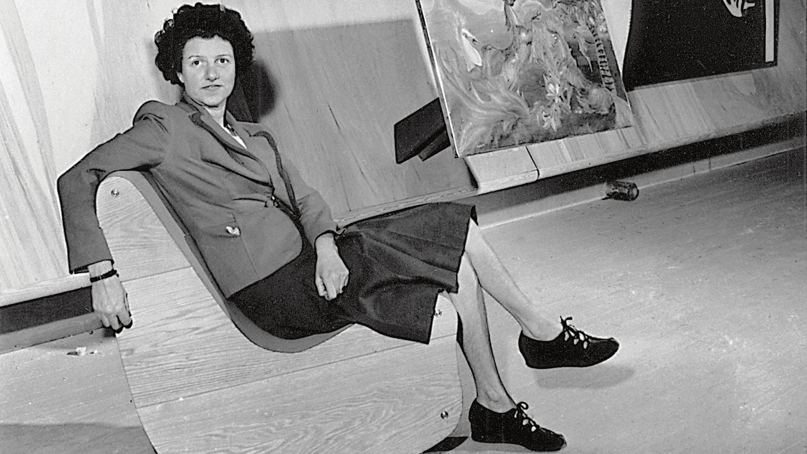 Guggenheim seated in gallery in front of abstract painting