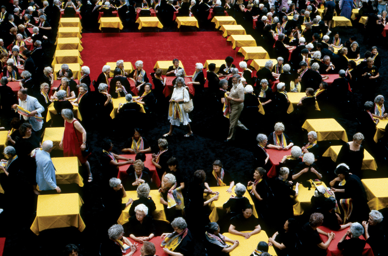 women at gathering to form a quilt formation