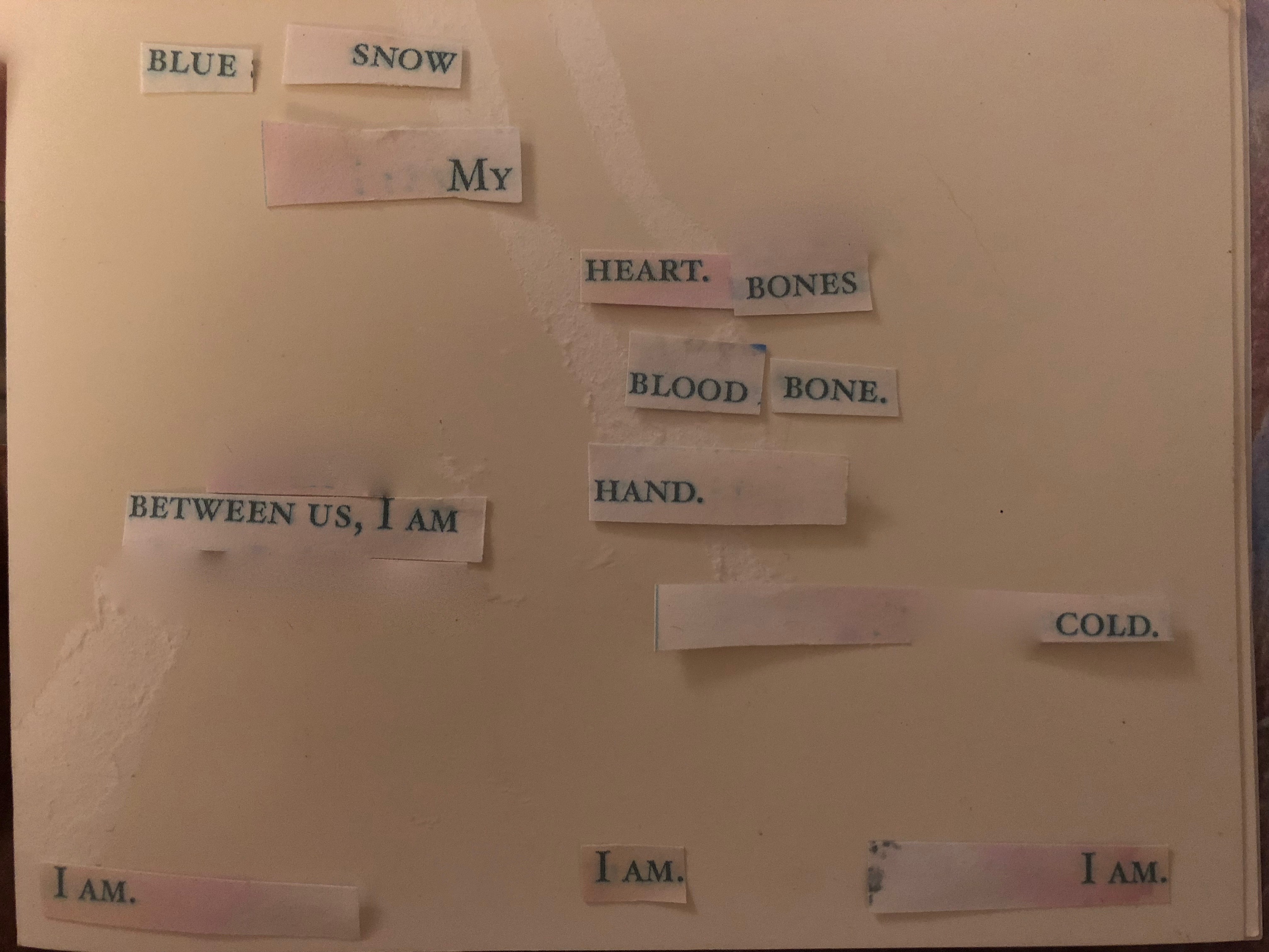 poem made of cut out words on pale pink